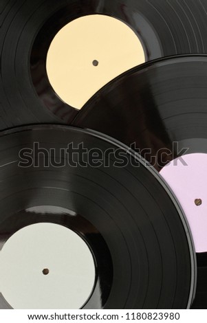 Vinyl records background. Close up vinyl records with different labels, vertical image. Vinyl records wallpaper.