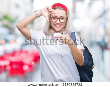 Young blonde student woman wearing glasses and backpack over isolated background smiling making frame with hands and fingers with happy face. Creativity and photography concept.