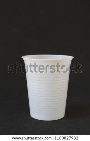 Diposable plastic cup on a black background