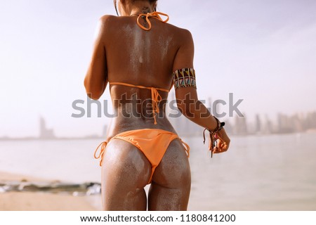 Fancy young girl on the beach in bikini, swimming in the sea, Dubai, surfing, surfboard, bronze tan, fruits, sport, holiday, summertime, hot, free, reckless, funny, perfect body, sunshine, soft skin