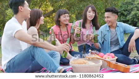 Asian Young friends enjoy the picnic time in the park