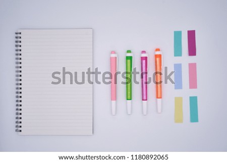 minimal white blank notebook with colourful pen and sticky labels on white background, can be used in idea, creative, business, school, office, finance theme