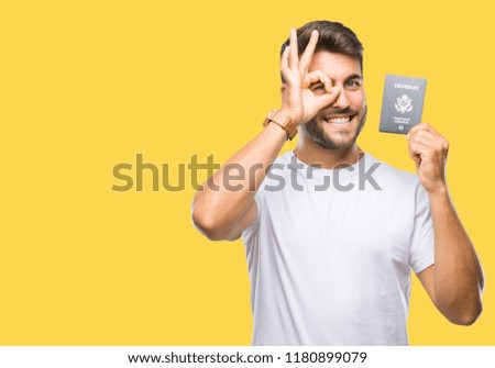Young handsome man holding passport of united states over isolated background with happy face smiling doing ok sign with hand on eye looking through fingers