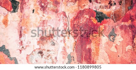 Painted yellow red old gypsum wall with an abstract pattern. Wide background and texture of a concrete wall. Wallpapers for desktop and design.