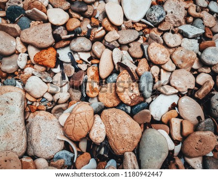 Pebbles texture. Rough structure mineral. Rock texture. Background of sea stone. Gravel texture