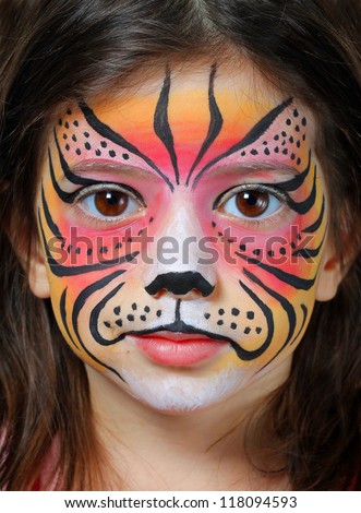 Pretty girl with face painting of a tiger