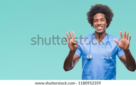 Afro american surgeon doctor man over isolated background showing and pointing up with fingers number nine while smiling confident and happy.