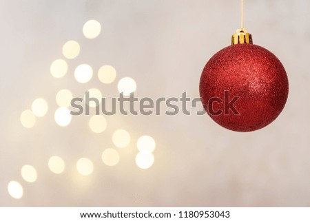Red christmas ball with defocused lights background