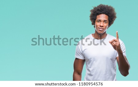Afro american man over isolated background showing and pointing up with finger number one while smiling confident and happy.