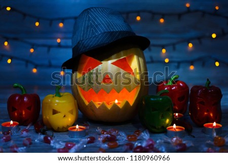 Close up photo of frifhtening scaring terrifying pumpkin with snall peppers in dark at night
