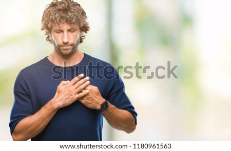 Handsome hispanic model man wearing winter sweater over isolated background smiling with hands on chest with closed eyes and grateful gesture on face. Health concept.