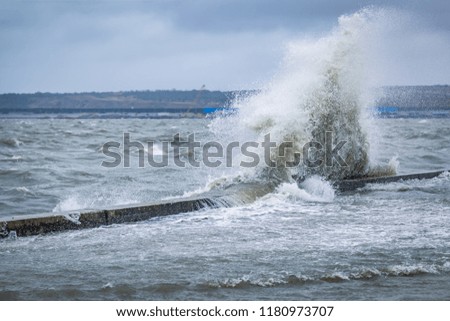 Big splash of wave on the flooded embankment of the resort city on the Black Sea