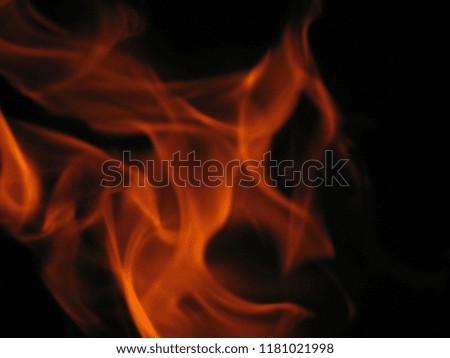 Burning flames of fire in the fireplace in a winter season