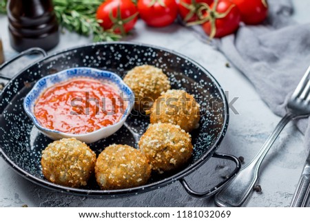 Chicken croquettes with tomato sauce