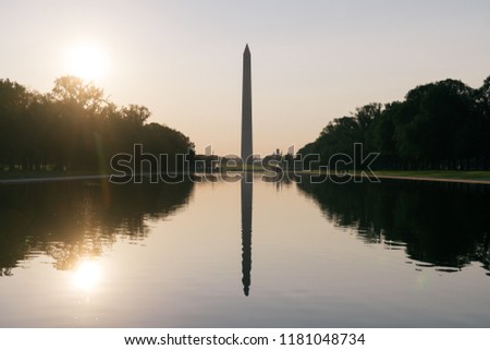 Washington Monument at sunrise, mirrored in the Reflecting Pool in Washington, D.C.
