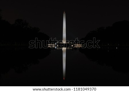 Washington Monument at night, mirrored in the Reflecting Pool in Washington, D.C.