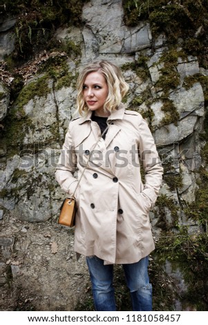 Blonde girl poses in forest