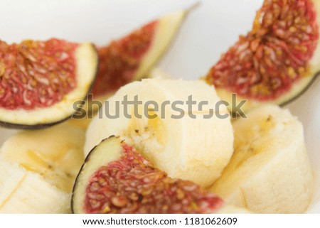bright colorful ripe fruit summer harvest wallpaper. healthy vegetarian fruits salad dish ingredients top view isolated on white background. yellow bananas and sliced figs.