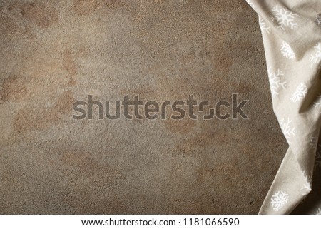 Kitchen stone table with towel. Top view with copy space. Concrete beige background with a touch of rust