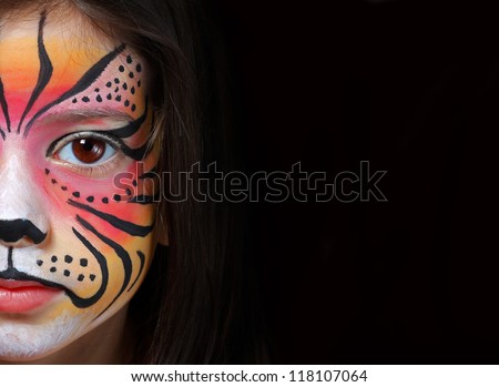 Pretty girl with face painting of a tiger Royalty-Free Stock Photo #118107064