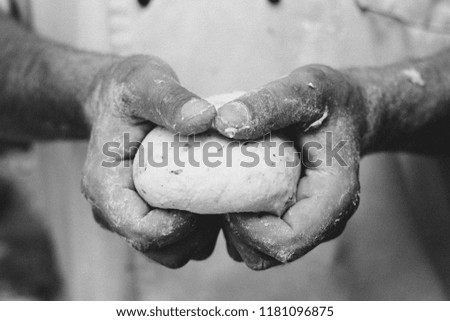 Dough in the hands of a baker in the center