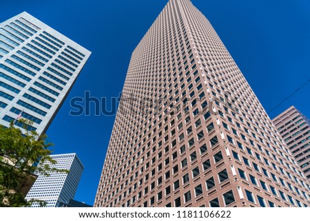 Looking straight up at Rising Skyscrapers in Downtown Denver , Colorado , USA blue sky nice summer day Modern Skyline Cityscape