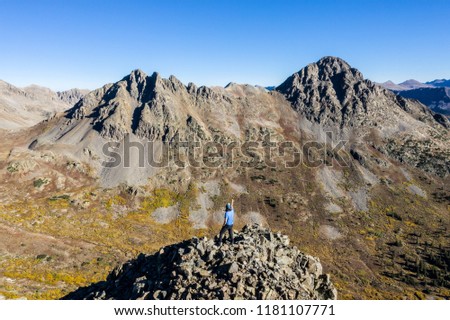 Aerial drone photo - Hiker atop a mountain in the Colorado Rockies.  Sawatch Range