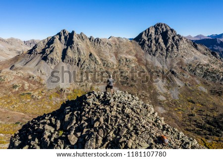 Aerial drone photo - Hiker atop a mountain in the Colorado Rockies.  Sawatch Range