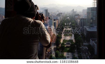 Silhouette image of man or tourist shooting photo at top of building.AT hokkaido japan