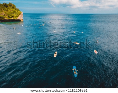 Aerial view with surfers in blue ocean, Bali