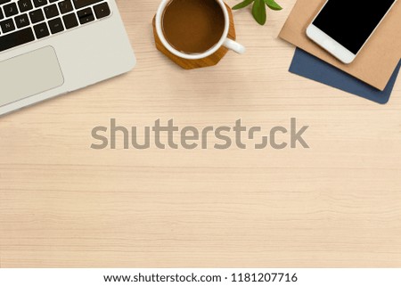 Office desk flat lay with hot coffee,laptop, notebook and smartphone on top view and copy space. Business desk minimal style concept.Work from home idea.