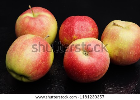 wet apples on a black background