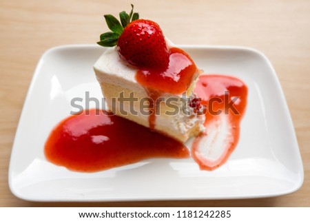 Strawberry cake was eaten on white plate.