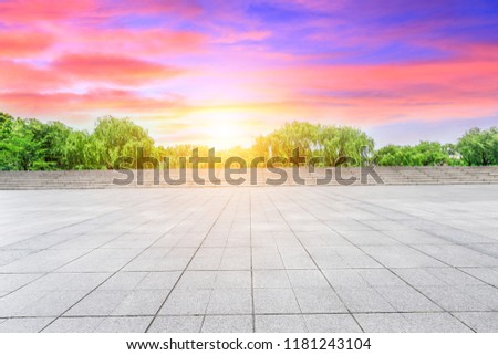 Empty square floor and green forest natural scenery at sunset