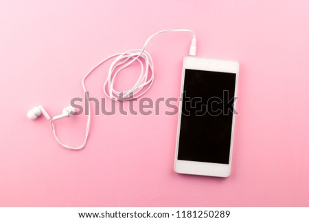 top view cell phone with headphones pink background