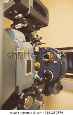Close up shot of a vintage movie projector in a cinema hall.