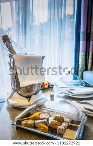 A bucket of champagne and fruit on the table