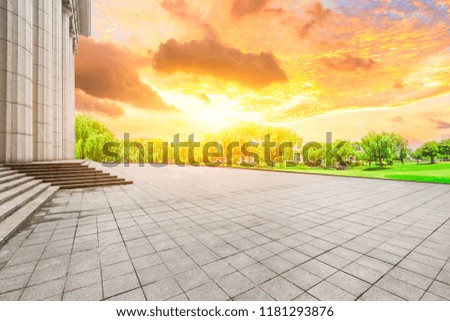 Empty square floor and modern urban architecture at sunset