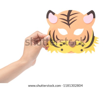 hand holding tiger animal carnival mask isolated on white background