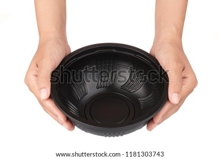 Hands holding Black of bowl isolated on white background.