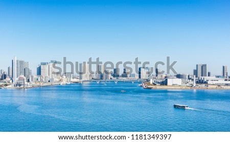Asia Business concept for real estate and corporate construction - panoramic city skyline aerial view of tokyo bay with mirror reflection under blue sky in odaiba, Tokyo, Japan