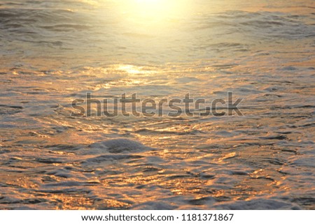 Golden and golden sea water at sunset or dawn. Beautiful sea sunset. Design with copy space.