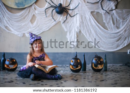 Hard to read. Learning in game. Learning to read. child changed into carnival costume. child is celebrating Halloween. Scary spider on the wall. Cut black pumpkin. Decor for Halloween. Copyspace