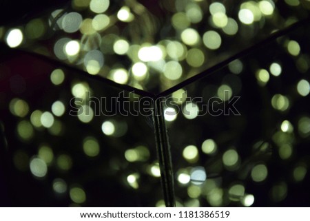 New Year lights blurring in front of bright pink background. Macro photo. Christmas background. Pink neon background and blurred lights. Holidays pattern. New Year Christmas Decorations