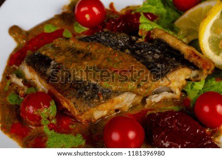 Baked halibut fish fillet with cherry tomato