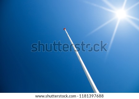 flagpole with no flag against blue sky