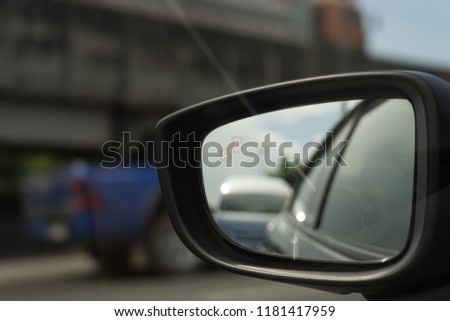 View of side mirror show light of blind spot for notice driver beware before chang lane. Royalty-Free Stock Photo #1181417959