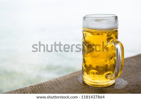 mug of cold craft beer on rough cement