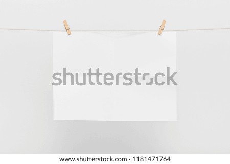 Blank Card Hanging on a Clothesline against White