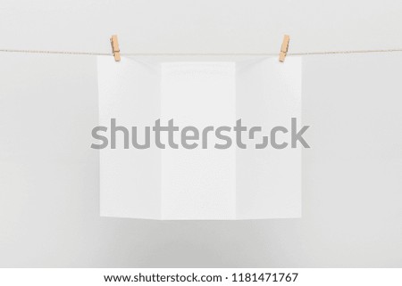 Blank Card Hanging on a Clothesline against White